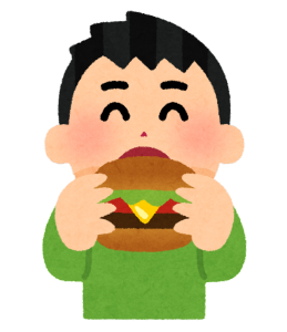 ハンバーガーを食べる男性
